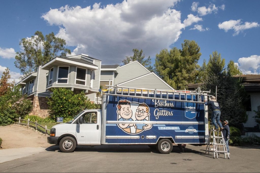 Crew setting up at the truck for a two-story install