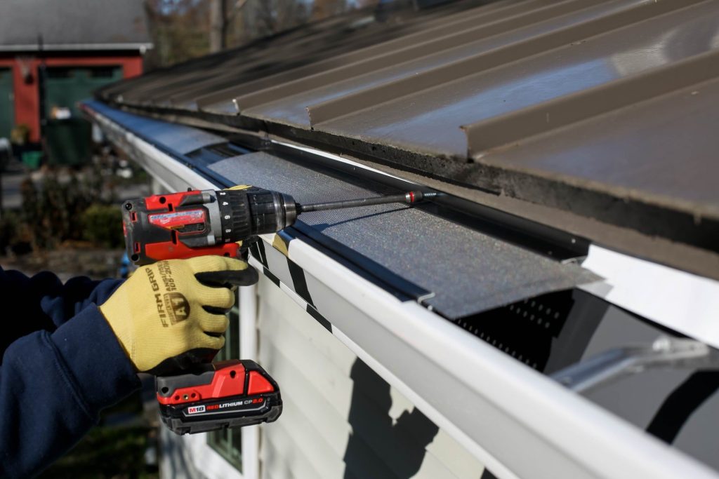 Installer fastening micro mesh gutter guard