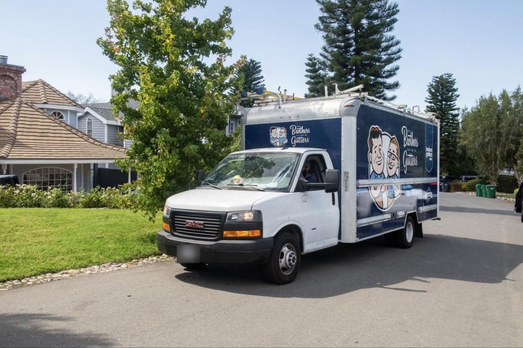 The Brothers That Just Do Gutters truck parked on a residential street
